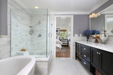 Tub/shower combo - traditional master marble floor tub/shower combo idea in San Francisco with an undermount sink, recessed-panel cabinets, dark wood cabinets, marble countertops and gray walls