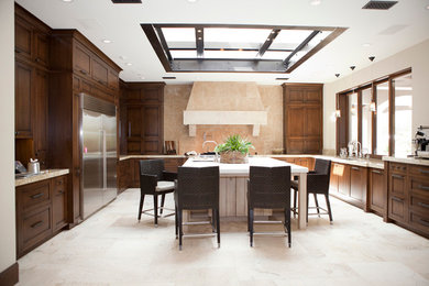 Photo of a transitional kitchen in San Diego with granite benchtops, travertine floors and with island.
