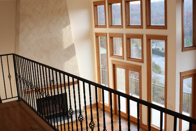 Inspiration for a mid-sized timeless formal and loft-style medium tone wood floor living room remodel in DC Metro with beige walls, a standard fireplace and a plaster fireplace