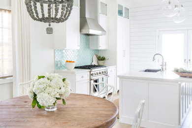 Inspiration for a mid-sized contemporary medium tone wood floor kitchen/dining room combo remodel in Other with white walls and no fireplace