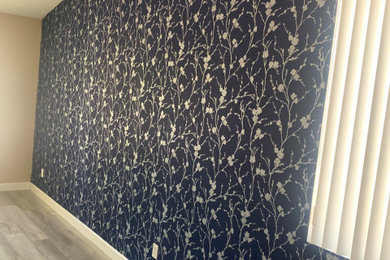 Example of a mid-sized transitional master wallpaper bedroom design in Phoenix with blue walls