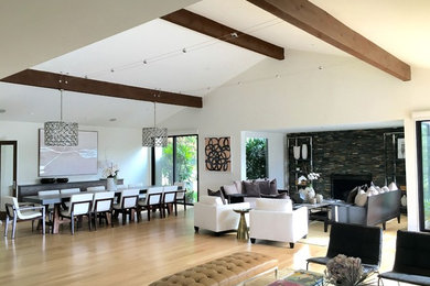 Example of a trendy open concept bamboo floor and beige floor living room design in Los Angeles with white walls