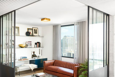 Example of a trendy formal and open concept light wood floor and beige floor living room design in Austin with white walls and no tv