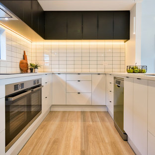 U-shaped kitchen with feature tiles and double oven