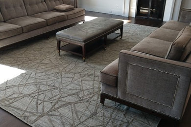 Inspiration for a large contemporary enclosed dark wood floor and brown floor family room remodel in New York with white walls, a standard fireplace, a wood fireplace surround and no tv