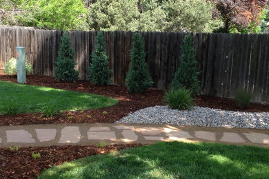Design ideas for a mid-sized backyard stone landscaping in Denver.