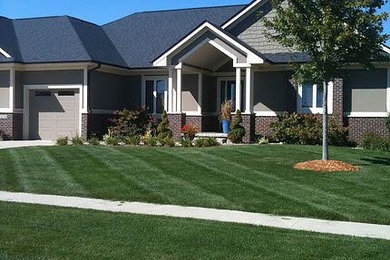 Mid-sized transitional gray one-story mixed siding house exterior idea in Other with a hip roof and a shingle roof