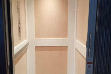 Small beach style wood wall entryway photo in Charleston