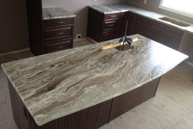 Example of a mid-sized beach style l-shaped kitchen pantry design in Toronto with granite countertops and an island