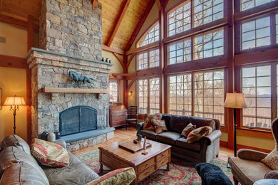 Photo of a large country open concept living room in Richmond with beige walls, medium hardwood floors, a standard fireplace and a stone fireplace surround.