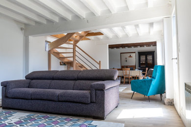 Inspiration for a medium sized contemporary open plan games room in Le Havre with white walls, light hardwood flooring, no fireplace, no tv, beige floors and exposed beams.