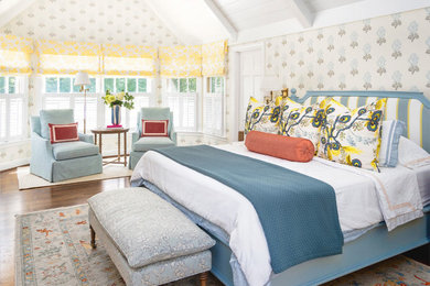 Example of a classic master medium tone wood floor, brown floor and vaulted ceiling bedroom design in Cincinnati with multicolored walls