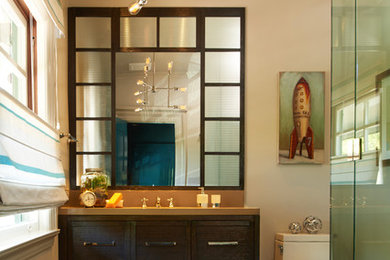Example of a mid-sized tuscan master porcelain tile doorless shower design in Los Angeles with an undermount sink, furniture-like cabinets, dark wood cabinets, glass countertops, a one-piece toilet and white walls