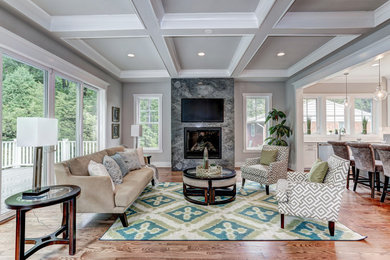 Example of a mid-sized classic formal and open concept light wood floor living room design in DC Metro with gray walls, a standard fireplace, a stone fireplace and a wall-mounted tv