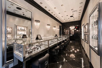 Inspiration for a mid-sized modern marble floor and black floor powder room remodel in New York with black cabinets, gray walls, marble countertops and black countertops