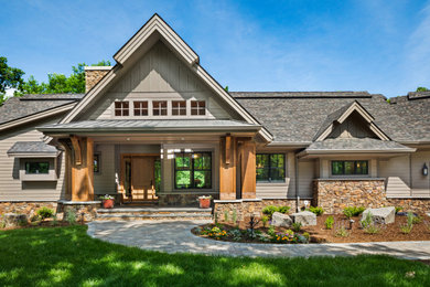 Example of a large gray one-story exterior home design in Minneapolis with a mixed material roof and a black roof