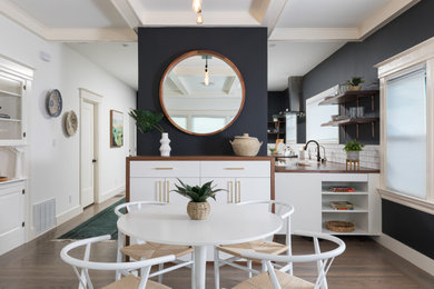 Design ideas for a contemporary dining room in San Francisco with black walls, dark hardwood floors and brown floor.