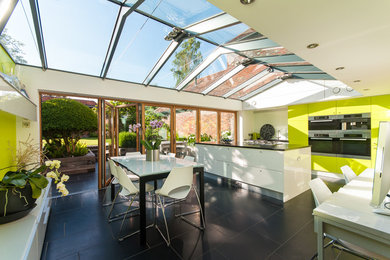 Design ideas for a contemporary open plan dining room in Oxfordshire with white walls.