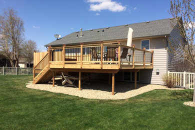 Mid-sized elegant backyard deck photo in Other with no cover
