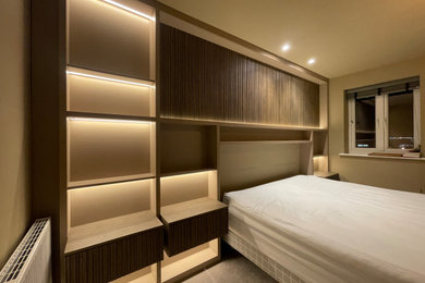 Inspiration for a medium sized contemporary master bedroom in Hertfordshire with beige walls, carpet and beige floors.