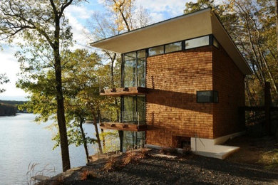 Inspiration for a mid-sized contemporary brown three-story wood and shingle exterior home remodel in Bridgeport with a metal roof and a black roof