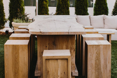 Example of a mid-sized minimalist courtyard patio kitchen design in Atlanta with an awning