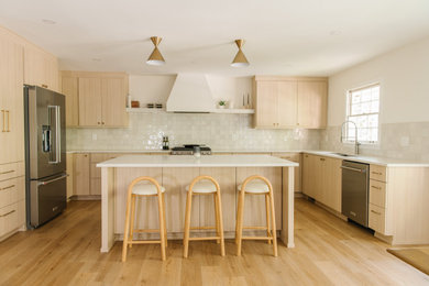 Large danish u-shaped light wood floor eat-in kitchen photo in Atlanta with an undermount sink, flat-panel cabinets, light wood cabinets, quartz countertops, white backsplash, ceramic backsplash, stainless steel appliances, an island and white countertops