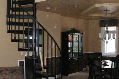 Large contemporary wood spiral staircase in Grand Rapids with open risers.