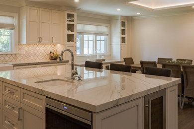 Inspiration for a large contemporary l-shaped dark wood floor and brown floor eat-in kitchen remodel in Miami with a farmhouse sink, beaded inset cabinets, white cabinets, stainless steel appliances and an island