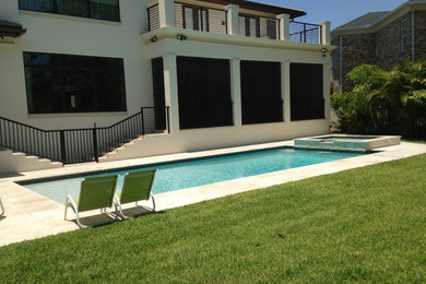 Pool - modern backyard tile and rectangular aboveground pool idea in Tampa