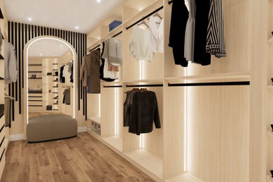 Large minimalist vinyl floor and brown floor walk-in closet photo in DC Metro with flat-panel cabinets and beige cabinets