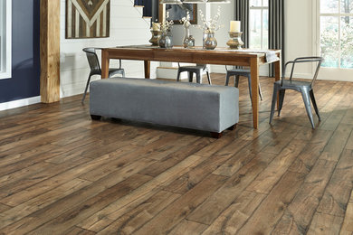 Inspiration for a mid-sized transitional laminate floor and brown floor great room remodel in Other with white walls and no fireplace