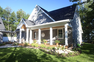 Small traditional gray two-story wood exterior home idea in Other with a shingle roof
