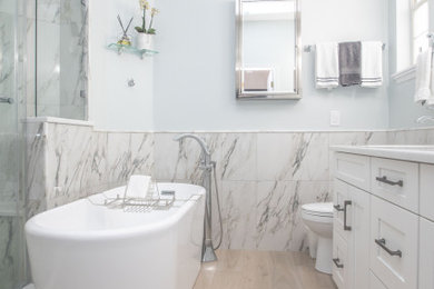 Bathroom - mid-sized transitional master multicolored tile and porcelain tile wood-look tile floor, beige floor and double-sink bathroom idea in Orlando with shaker cabinets, white cabinets, an undermount sink, quartz countertops, white countertops and a built-in vanity