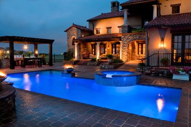 Hot tub - mid-sized mediterranean backyard concrete paver and rectangular lap hot tub idea in New Orleans