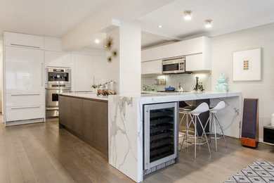 Open concept kitchen - mid-sized contemporary l-shaped light wood floor and brown floor open concept kitchen idea in New York with an undermount sink, flat-panel cabinets, dark wood cabinets, marble countertops, green backsplash, stone slab backsplash, stainless steel appliances and an island