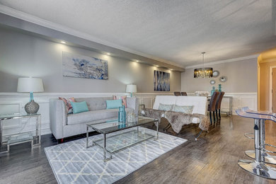 Large transitional open concept dark wood floor and brown floor living room photo in Toronto with gray walls