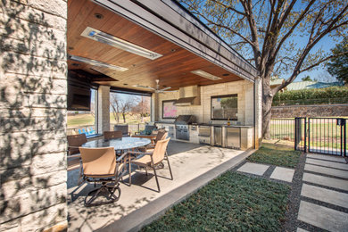 Mid-sized minimalist backyard concrete patio kitchen photo in Dallas with a gazebo
