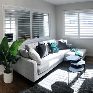 Design ideas for a small modern enclosed home cinema in Central Coast with grey walls, bamboo flooring, a built-in media unit and brown floors.