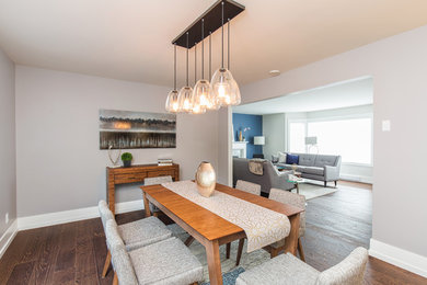 Inspiration for a modern dark wood floor dining room remodel in Vancouver with gray walls