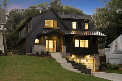 Large elegant black two-story shingle house exterior photo in Minneapolis with a shingle roof and a black roof