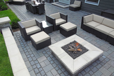 Inspiration for a large contemporary backyard concrete paver patio remodel in Detroit with a fire pit and no cover