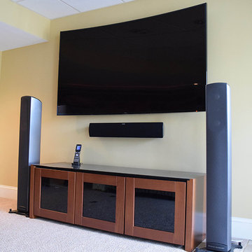 Curved TV Mounted w/ Center Channel, Floorstanding Speakers, AV Cabinet & Remote