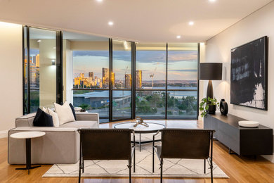 Large contemporary galley open plan kitchen in Perth with flat-panel cabinets, dark wood cabinets, solid surface benchtops, white splashback, engineered quartz splashback, with island and white benchtop.