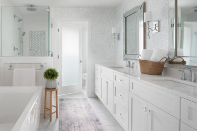 Inspiration for a large master porcelain tile, white floor, double-sink and wainscoting bathroom remodel in Milwaukee with shaker cabinets, white cabinets, an undermount sink, quartz countertops, white countertops and a built-in vanity