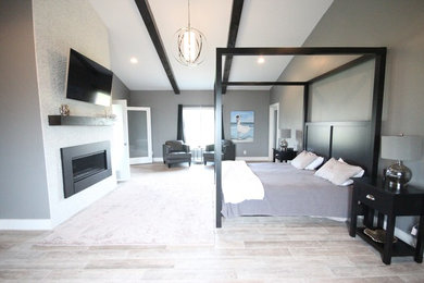 Large minimalist master ceramic tile bedroom photo in Other with gray walls, a standard fireplace and a tile fireplace