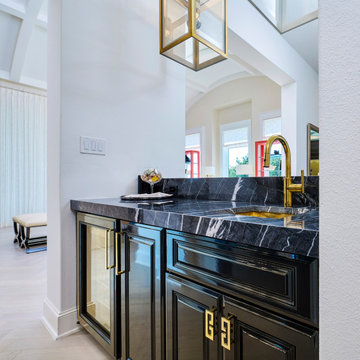 High-gloss black cabinets in a home bar and butler's pantry