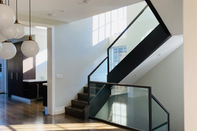 Large minimalist l-shaped glass railing staircase photo in Chicago