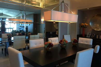 Dining room - large modern travertine floor dining room idea in Miami with beige walls