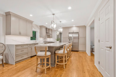 Example of a huge transitional l-shaped open concept kitchen design in Baltimore with a farmhouse sink, recessed-panel cabinets, light wood cabinets, quartz countertops, quartz backsplash, stainless steel appliances and an island